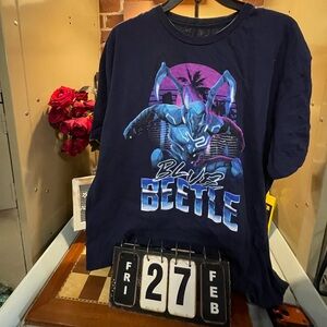 Blue Beetle Adult T-Shirt - Crouching In Front of Pink Sunset
